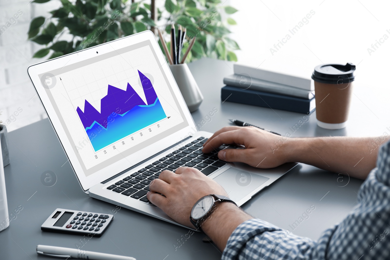 Image of  Broker working with laptop at table, closeup. Forex trading