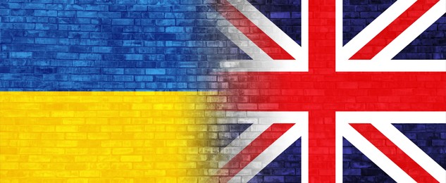 Flags of United Kingdom and Ukraine on brick wall, banner design. International diplomatic relationships