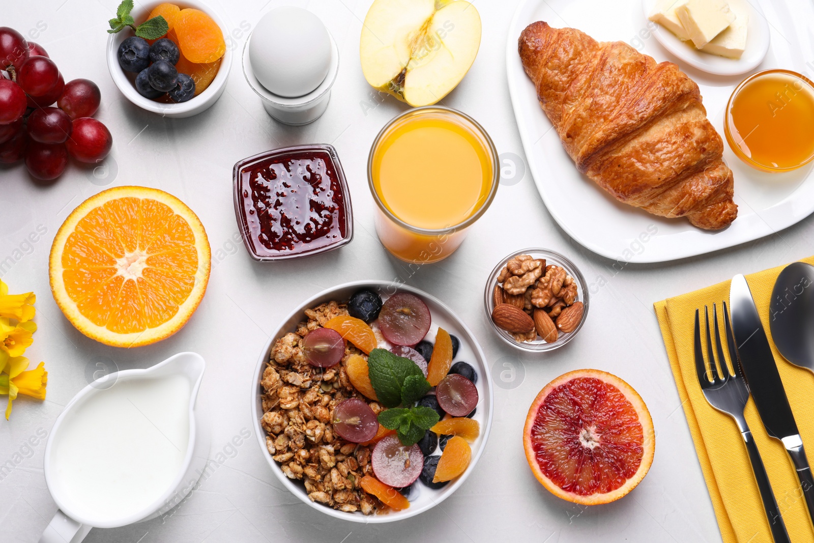 Photo of Delicious breakfast with granola on white background, flat lay