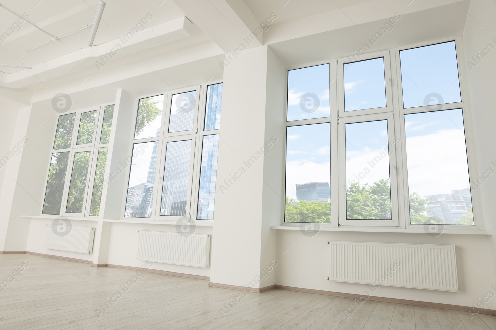 Photo of Modern office room with white walls and windows. Interior design