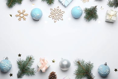 Composition with Christmas decorations on white background, top view. Winter season