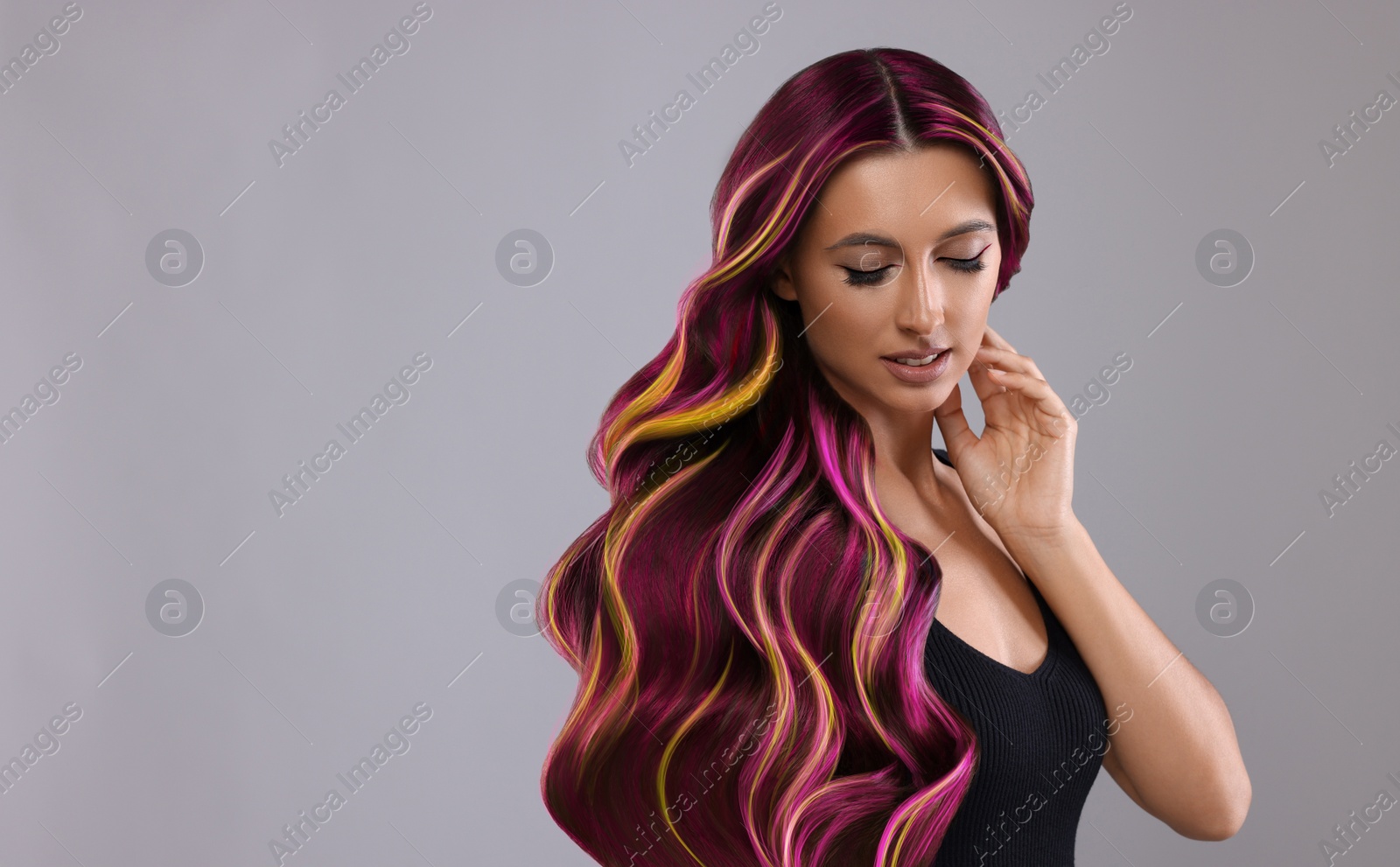 Image of Hair styling. Attractive woman with colorful hair on grey background, space for text