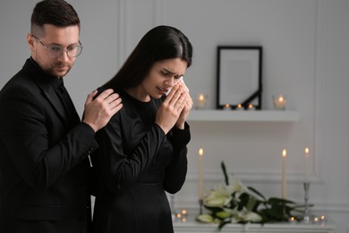 Photo of Sad couple mourning indoors, space for text. Funeral ceremony
