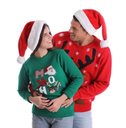 Photo of Beautiful happy couple in Santa hats and Christmas sweaters on white background