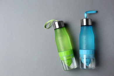 Photo of Sport bottles with space for text on color background, top view