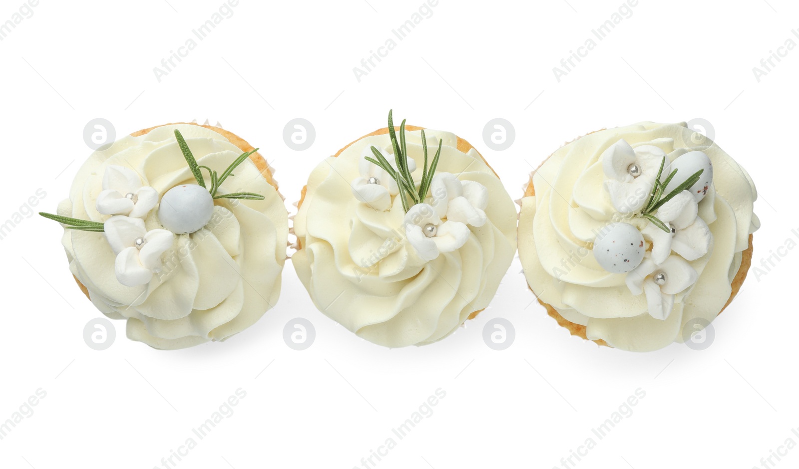 Photo of Tasty Easter cupcakes with vanilla cream isolated on white, top view