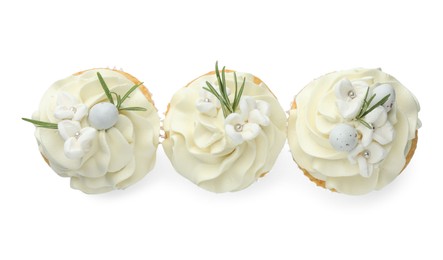 Tasty Easter cupcakes with vanilla cream isolated on white, top view