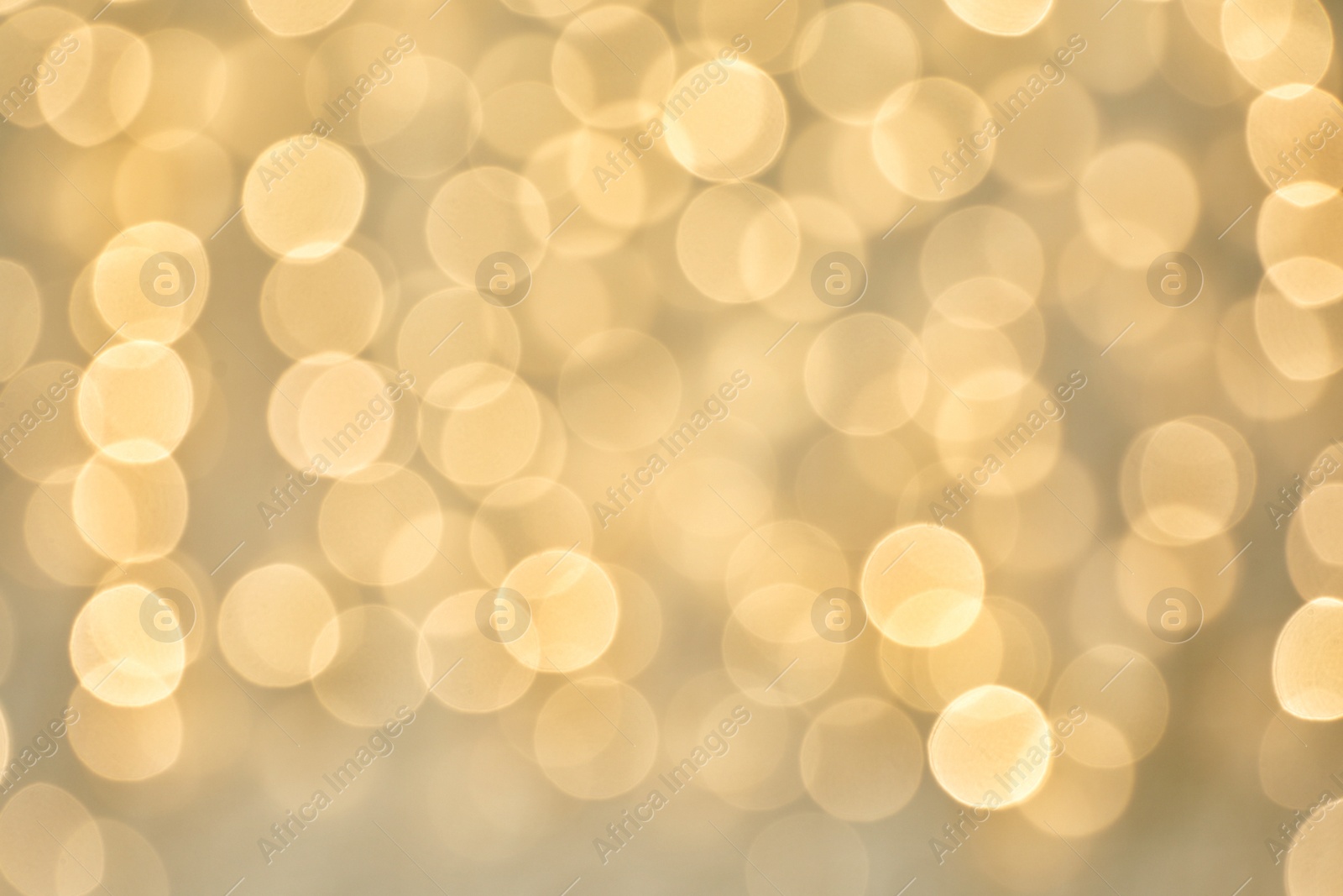 Photo of Blurred view of golden Christmas lights as background. Bokeh effect