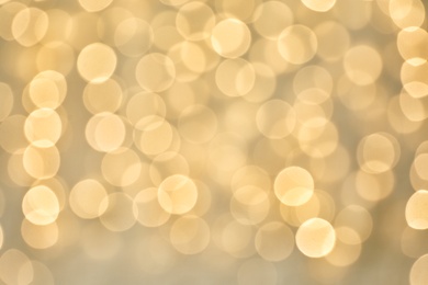 Blurred view of golden Christmas lights as background. Bokeh effect