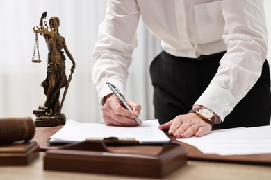 Photo of Lawyer working with documents at table in office, closeup