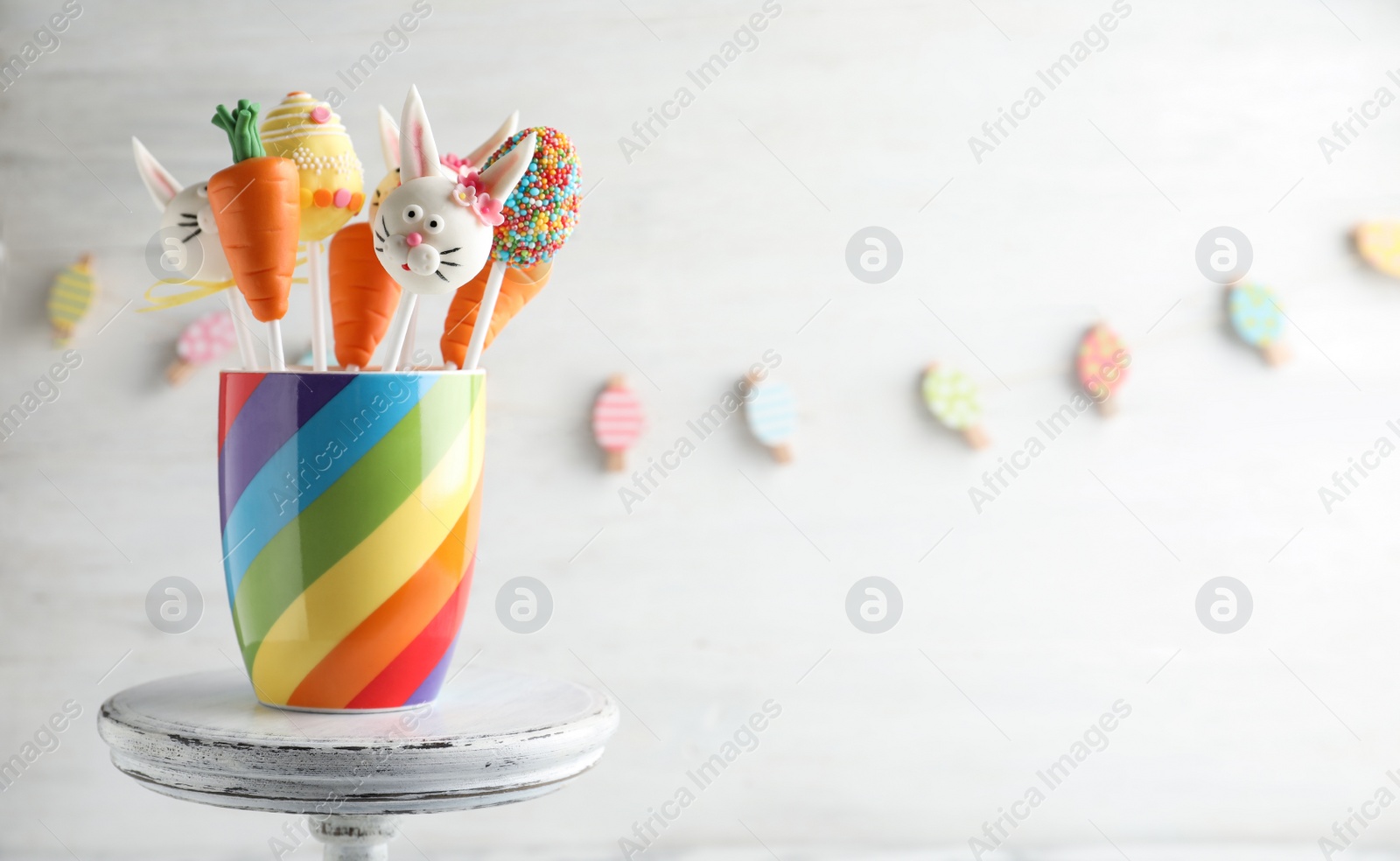 Photo of Delicious sweet cake pops on light background, space for text. Easter holiday