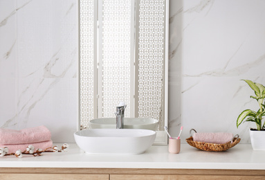 Modern mirror and vessel sink in stylish bathroom