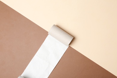 Photo of Flat lay composition with empty roll and toilet paper on color background. Space for text