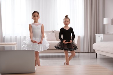 Photo of Cute little girls taking online dance class at home