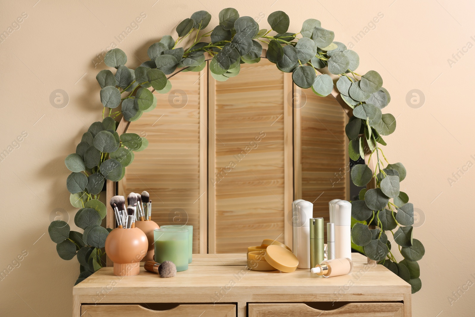 Photo of Dressing table with stylish mirror and cosmetic products