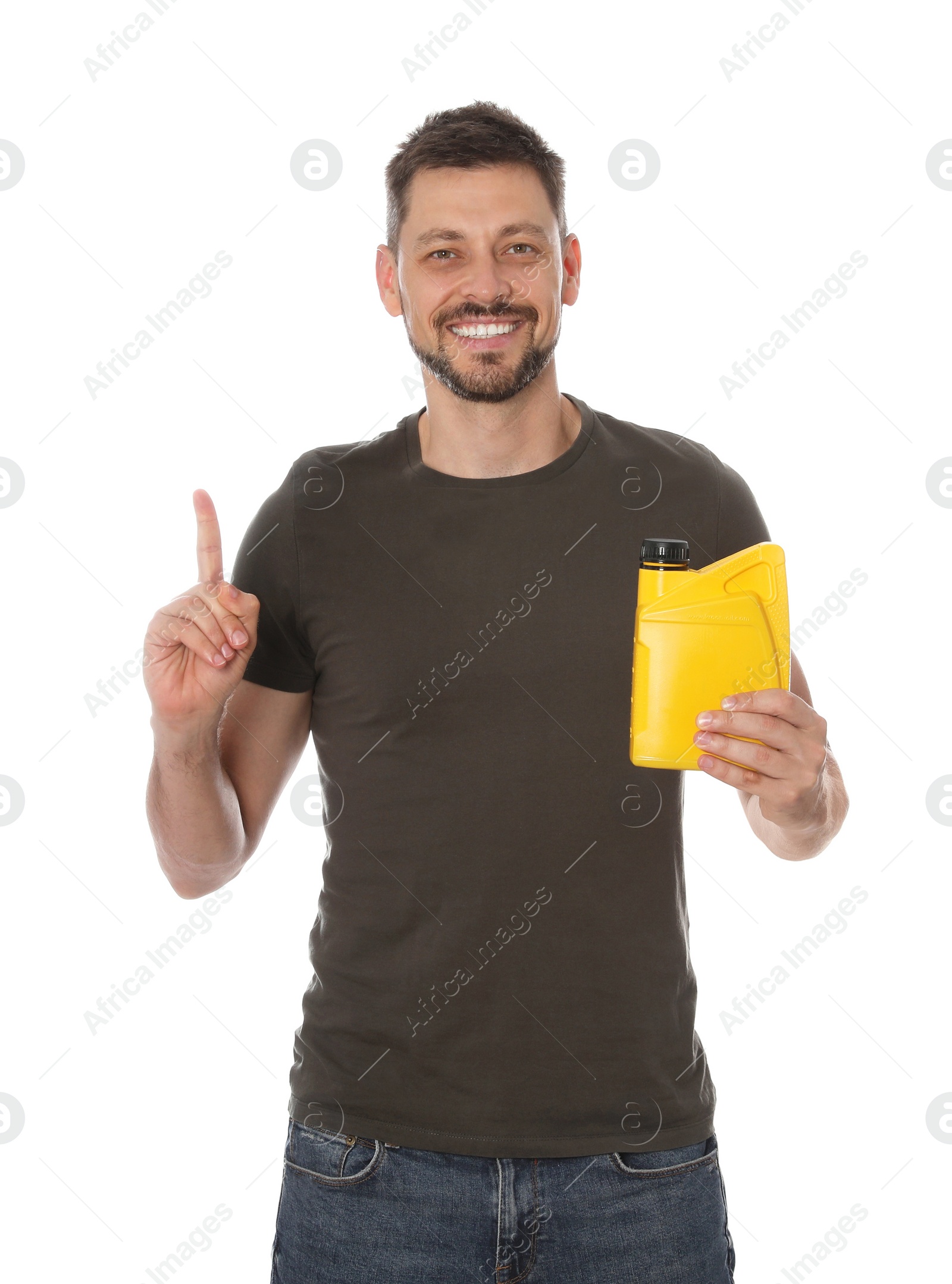 Photo of Man holding yellow container of motor oil and pointing up on white background