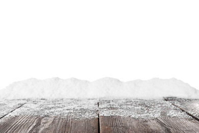 Photo of Heap of snow on wooden surface against white background