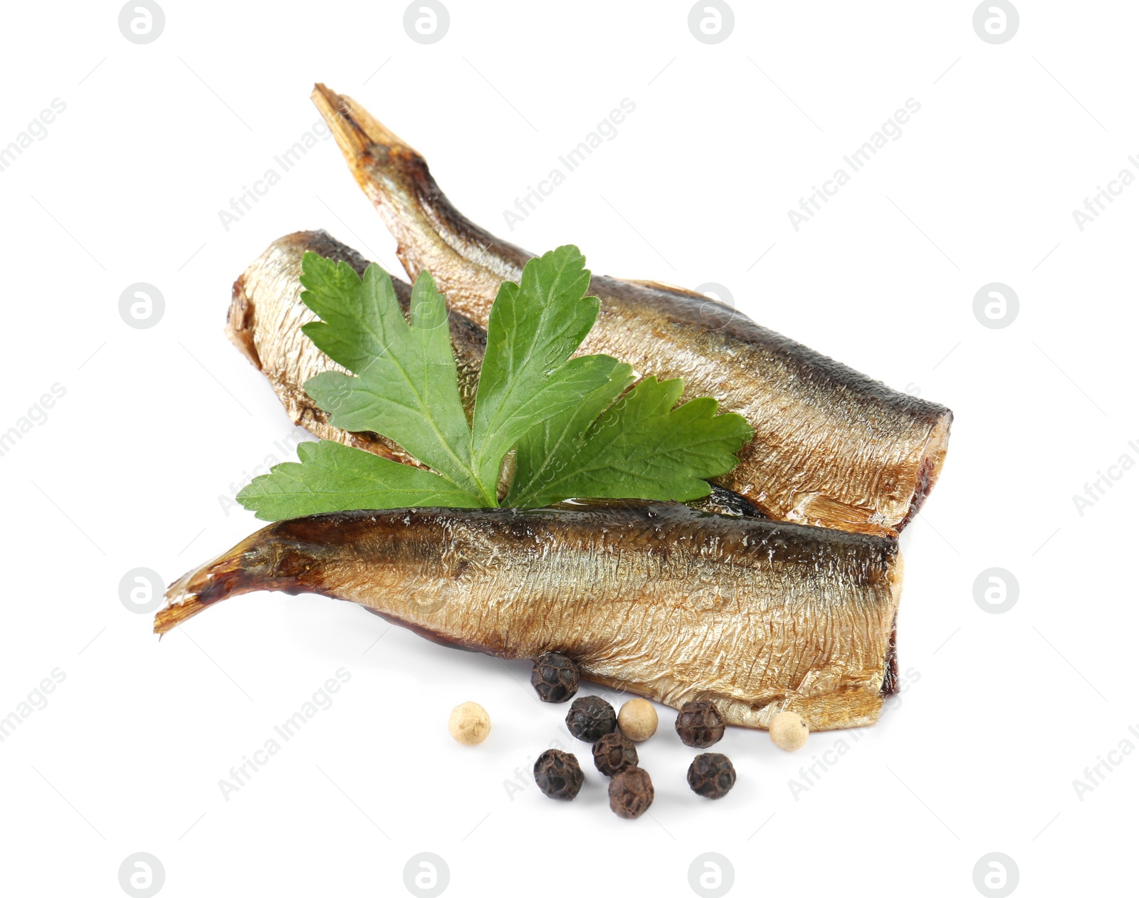 Photo of Tasty canned sprats, parsley and peppercorns isolated on white