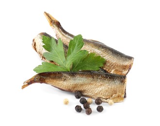 Photo of Tasty canned sprats, parsley and peppercorns isolated on white