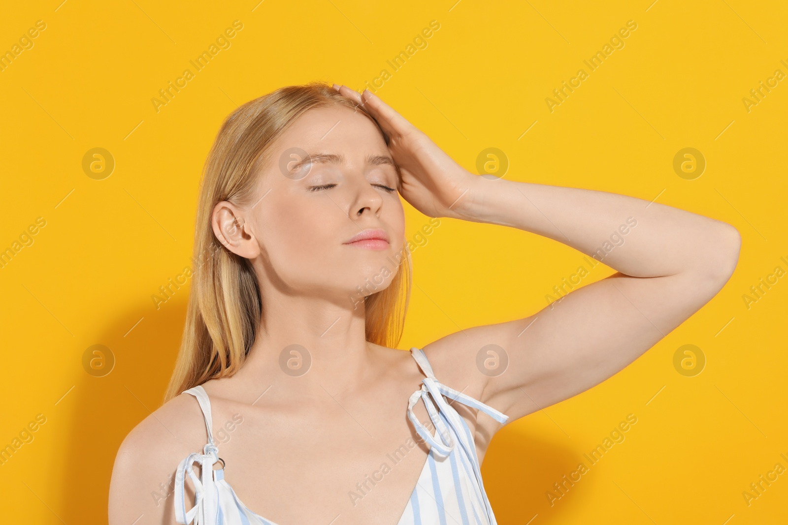 Photo of Beautiful young woman posing on orange background