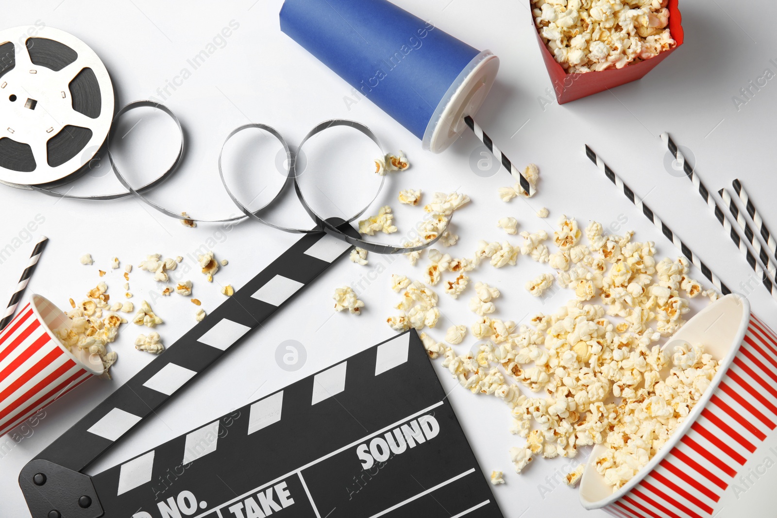 Photo of Flat lay composition with popcorn on white background. Cinema snack