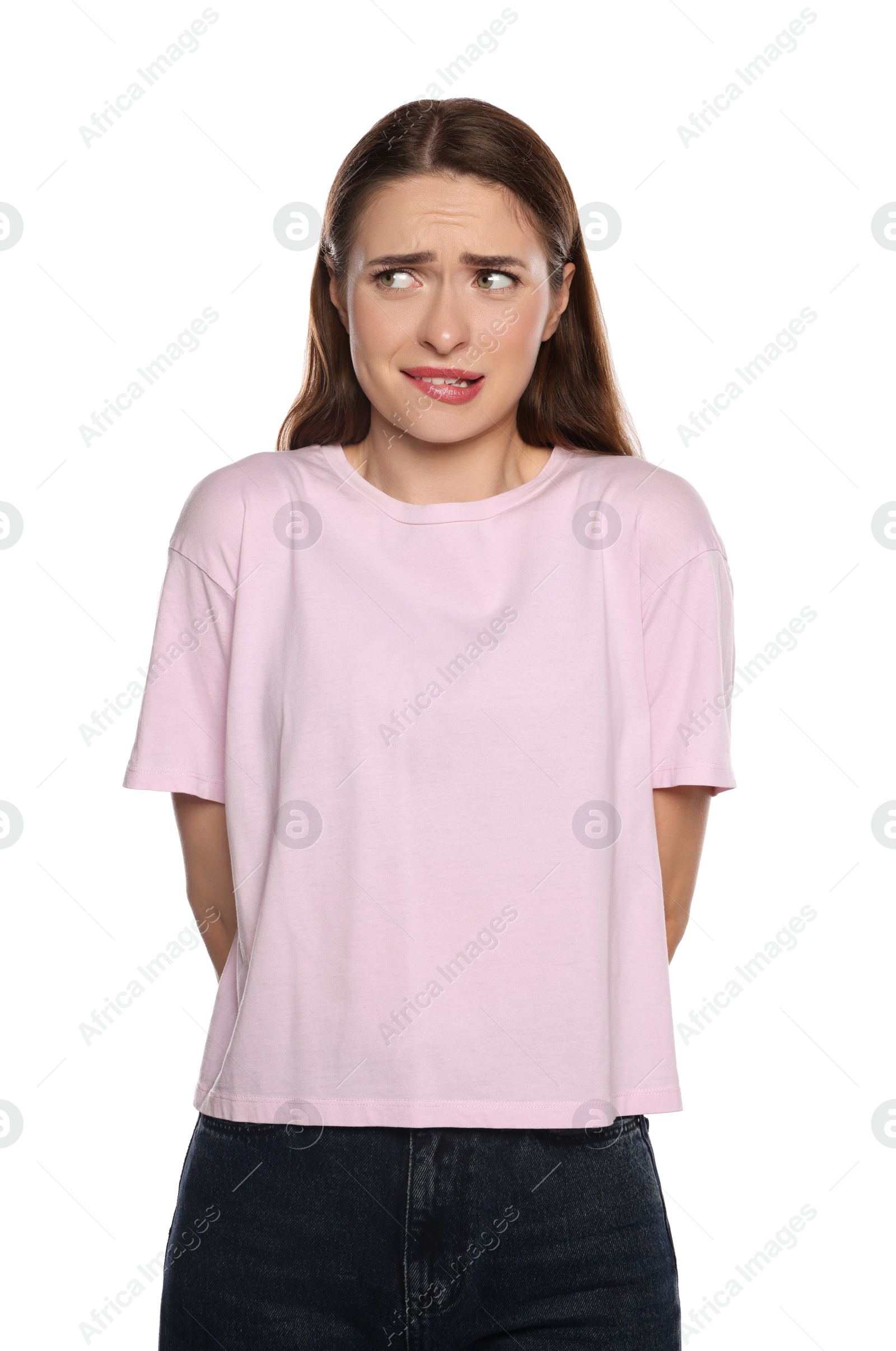 Photo of Embarrassed young woman in shirt on white background