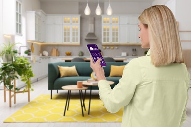 Image of Woman using smart home control system via application on mobile phone indoors