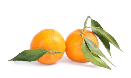 Photo of Tasty ripe tangerines with leaves on white background