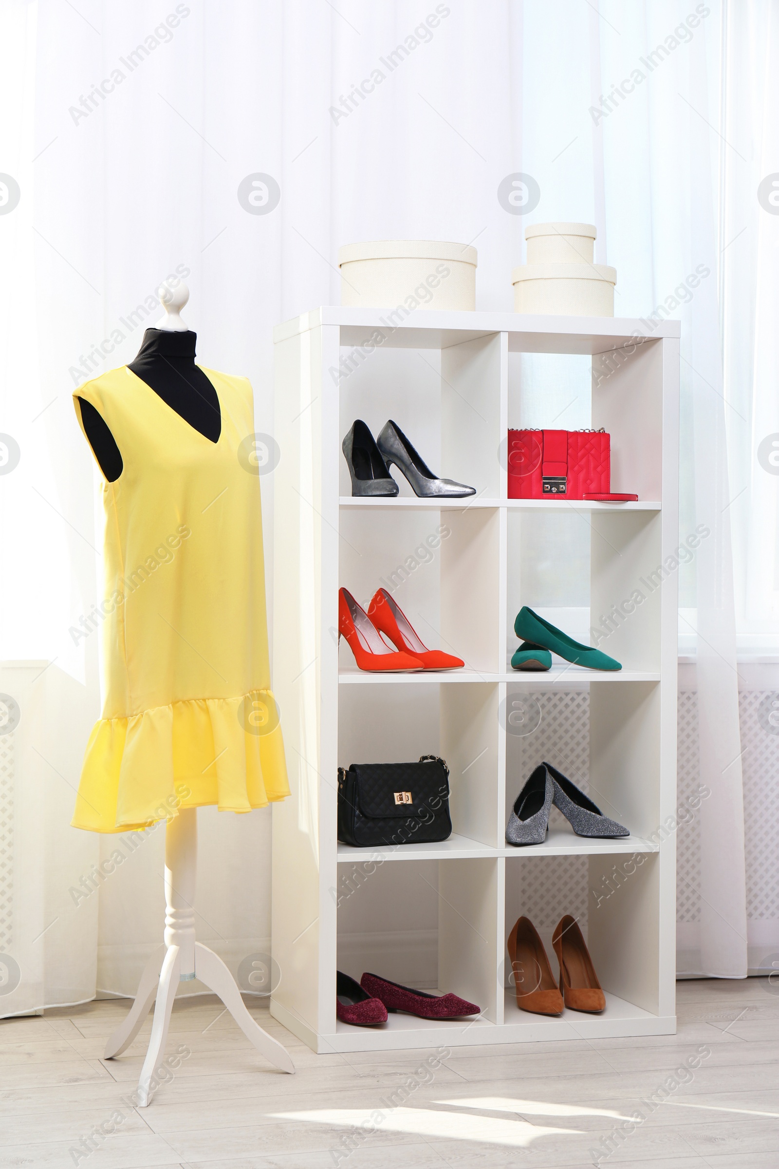 Photo of Shelving unit with shoes and purses in stylish dressing room interior