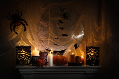 Different Halloween decor on fireplace indoors. Festive interior