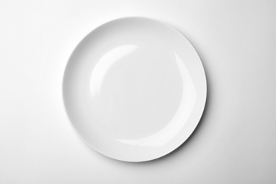 Photo of Clean empty plate on white background, top view