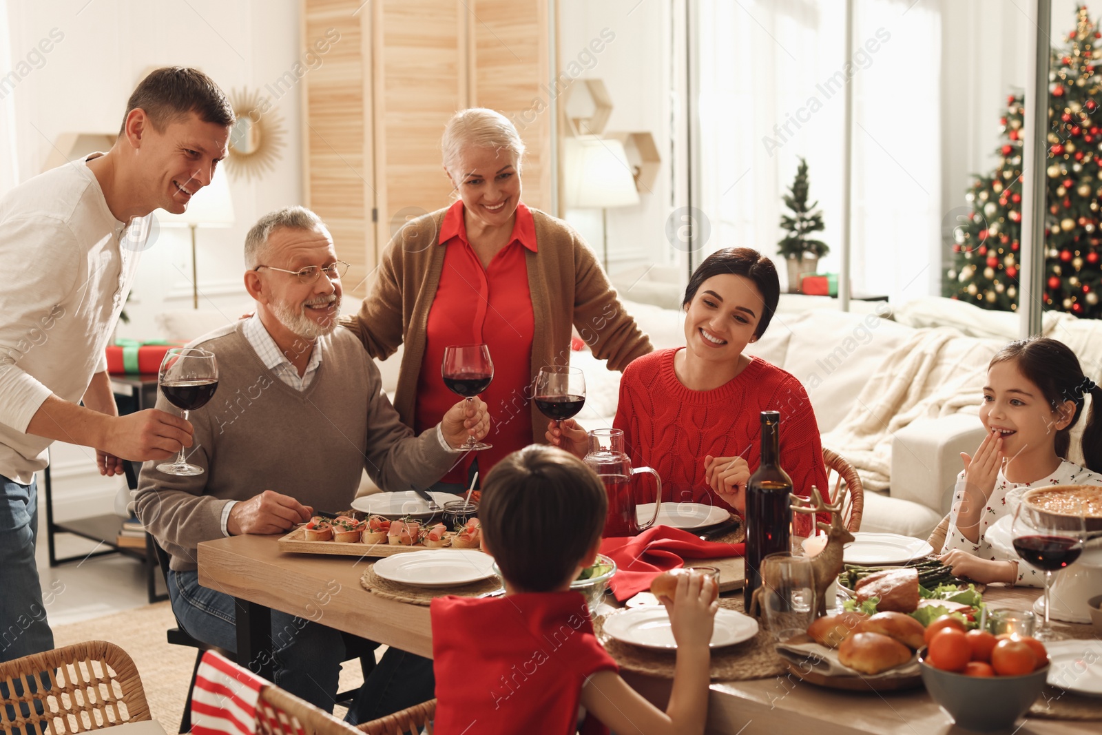 Photo of Happy family enjoying festive dinner at home. Christmas celebration