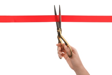 Photo of Woman cutting red ribbon with scissors on white background. Traditional ceremony