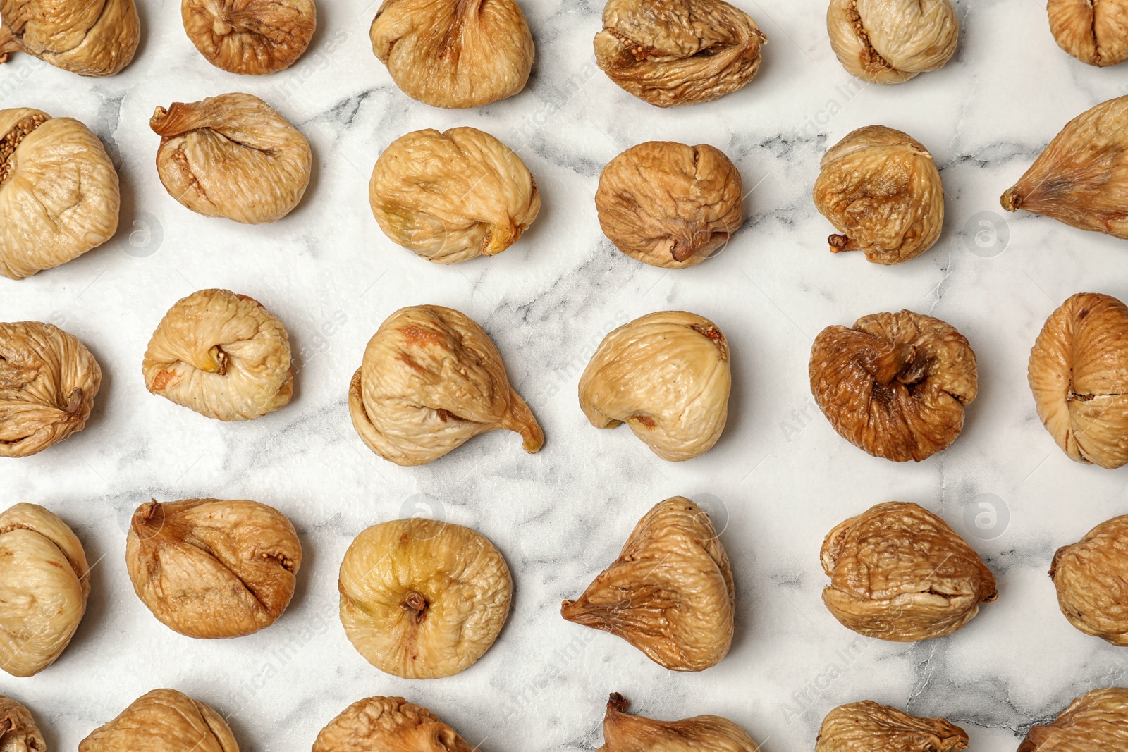 Photo of Flat lay composition with figs on marble background. Dried fruit as healthy food