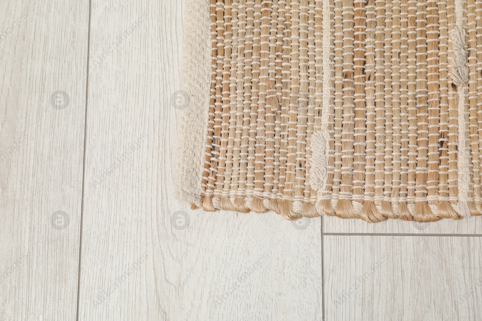 Photo of Soft carpet with pattern on white laminated floor indoors, top view. Space for text