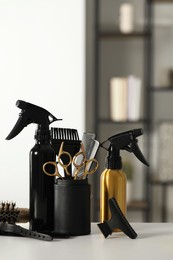 Photo of Set of hairdresser tools on table in salon