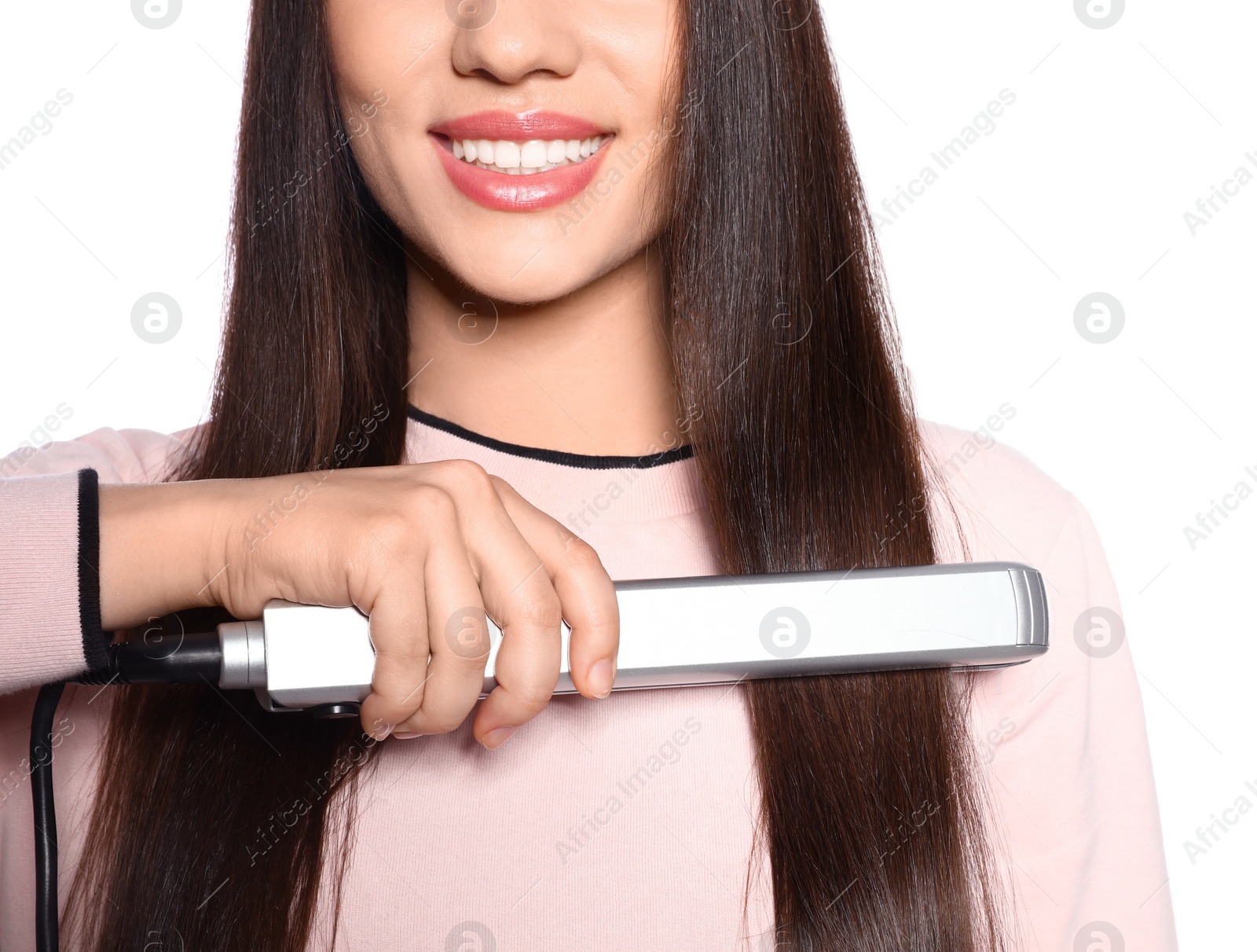 Photo of Happy woman using hair iron on white background, closeup