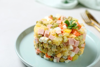 Traditional salad Olivier served on light table