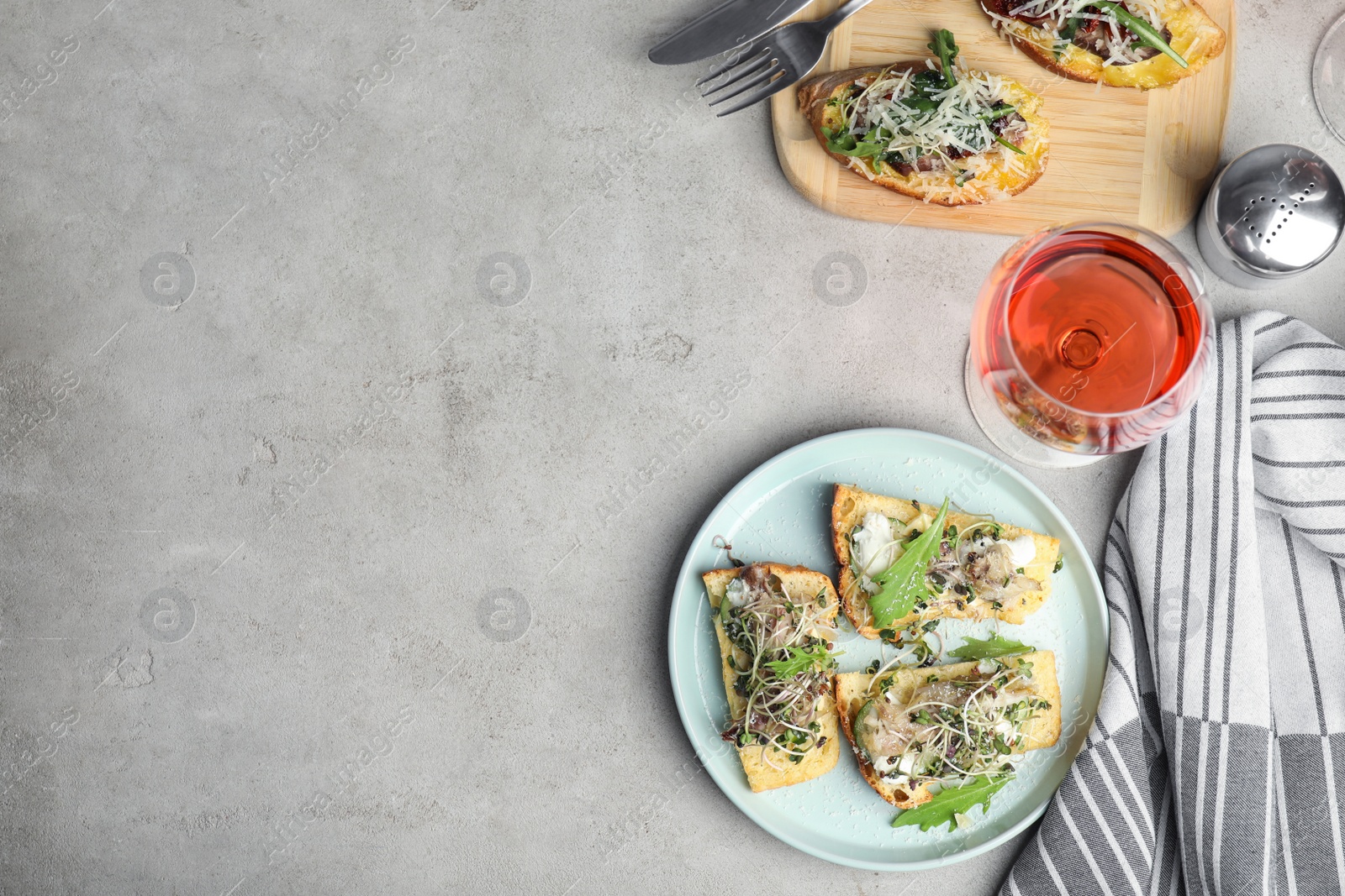 Photo of Delicious bruschettas served on light table, flat lay. Space for text