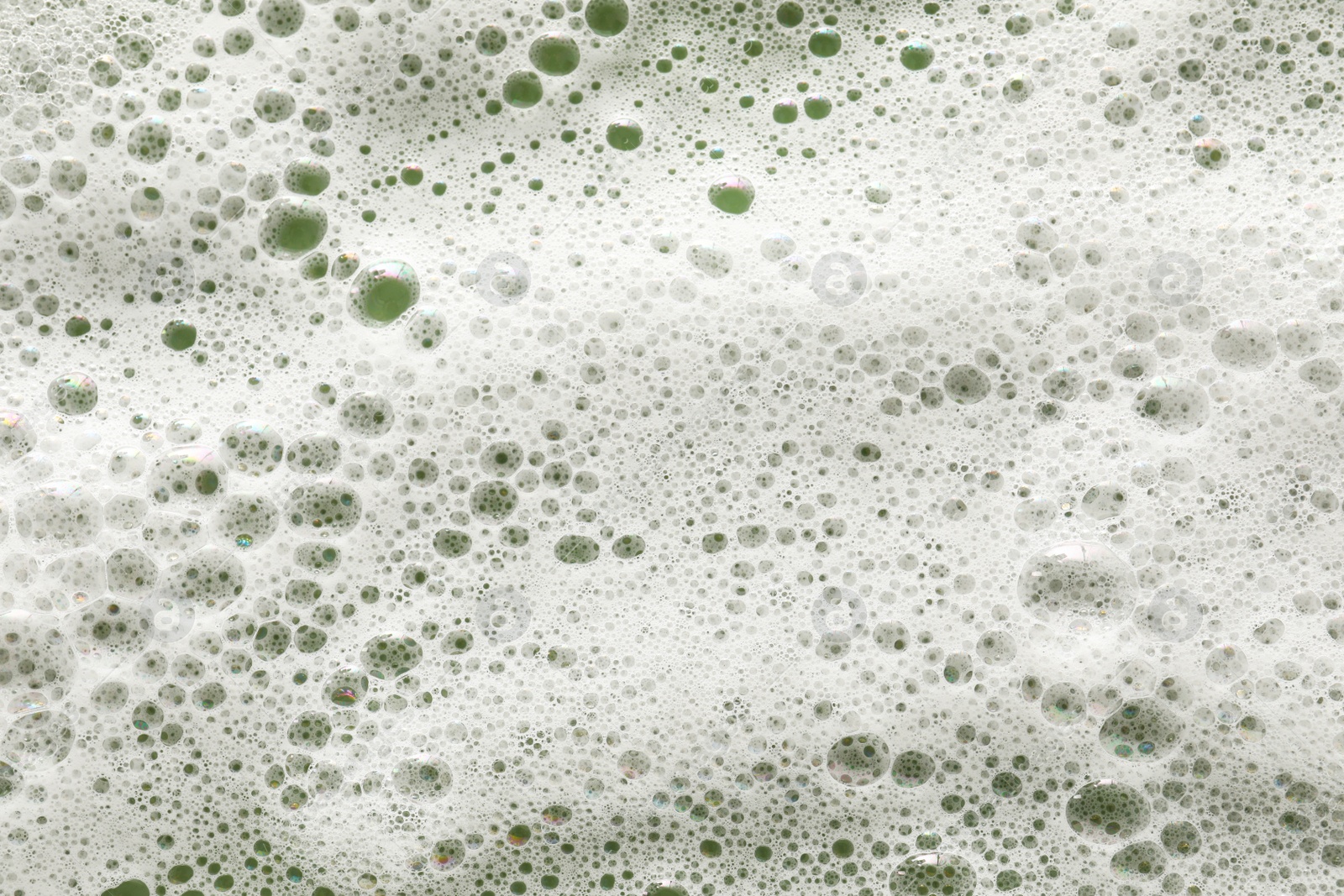 Photo of White washing foam on olive background, top view