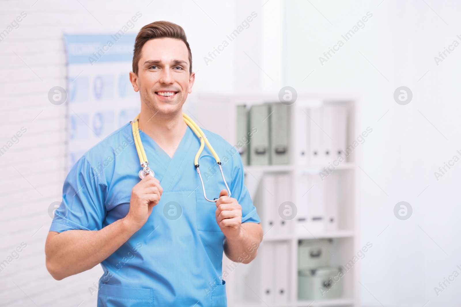 Photo of Portrait of medical assistant with stethoscope in hospital. Space for text
