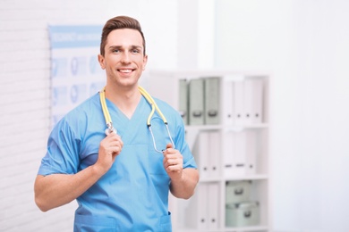 Portrait of medical assistant with stethoscope in hospital. Space for text