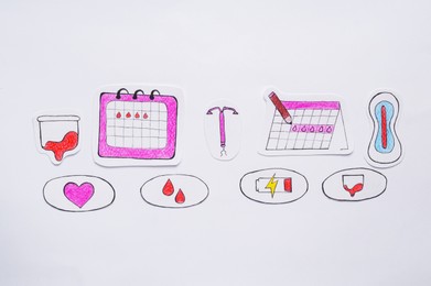 Photo of Woman`s health. Different paper figures on white background, flat lay