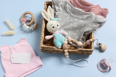 Flat lay composition with different baby accessories on light blue background