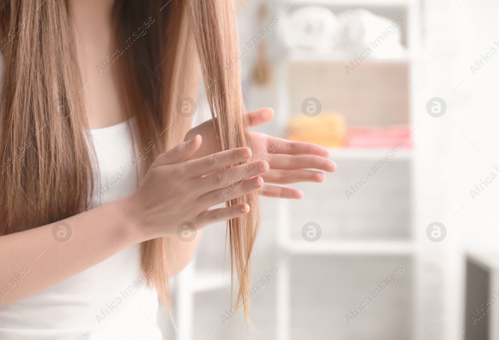 Photo of Young woman with beautiful long hair at home