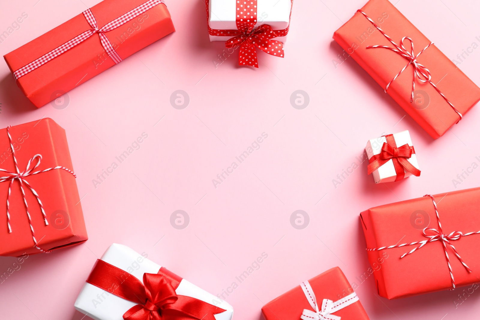 Photo of Beautifully wrapped gift boxes on color background, top view