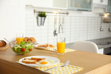 Tasty breakfast served on table in kitchen