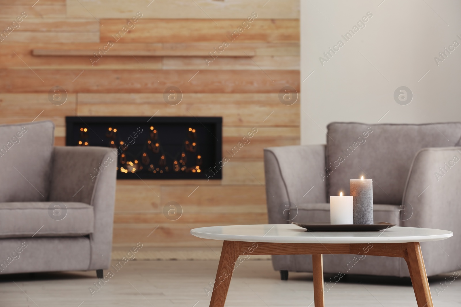 Photo of Room interior with armchairs and burning candles on table