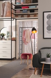 Photo of Modern wardrobe room interior with stylish furniture