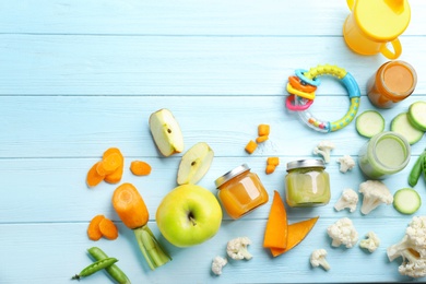 Photo of Flat lay composition with baby food and ingredients on wooden background
